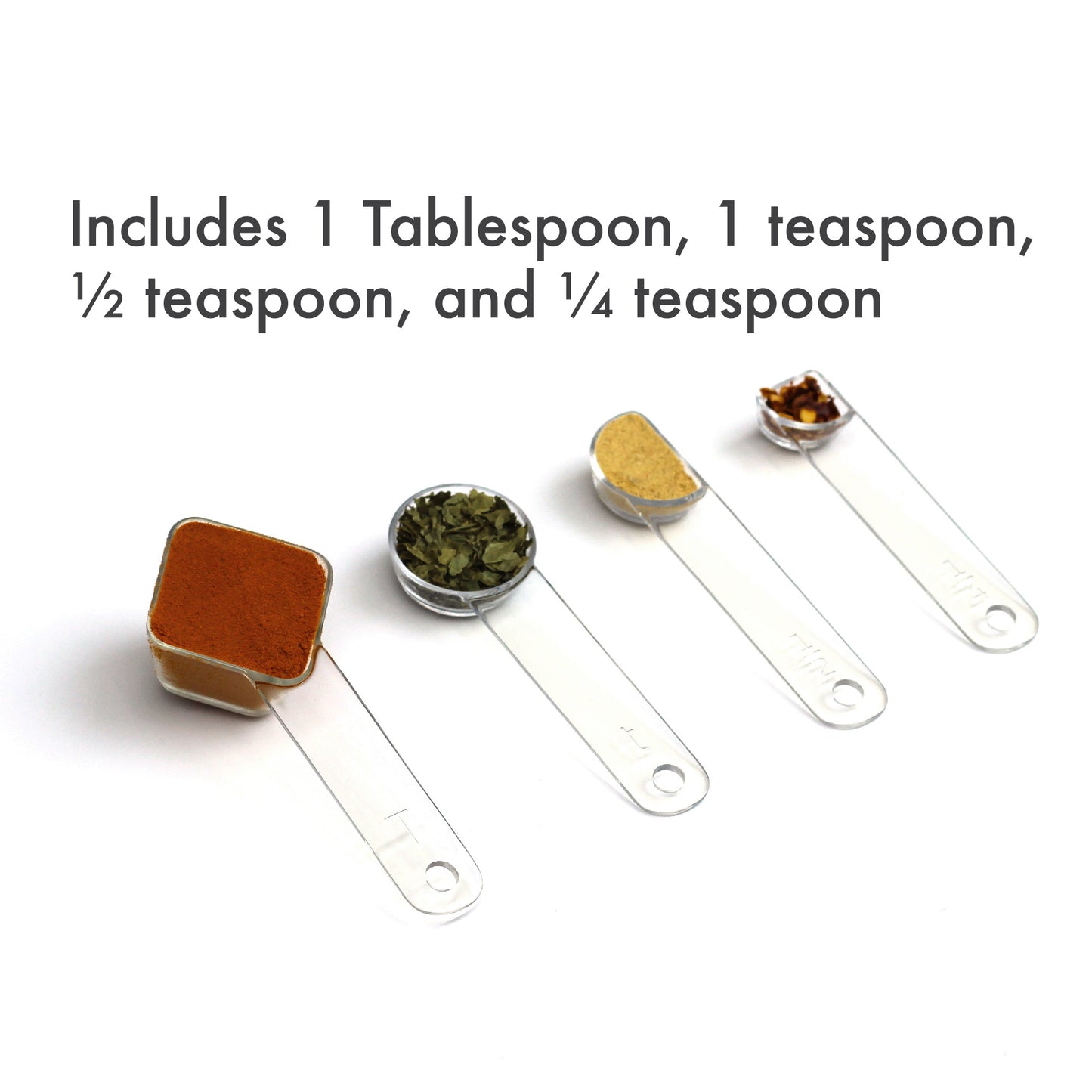 visual measuring spoons arrayed on an angle and filled with colorful spices. Caption say includes 1 tablespoon, 1 teaspoon, half teaspoon, and quarter teaspoon