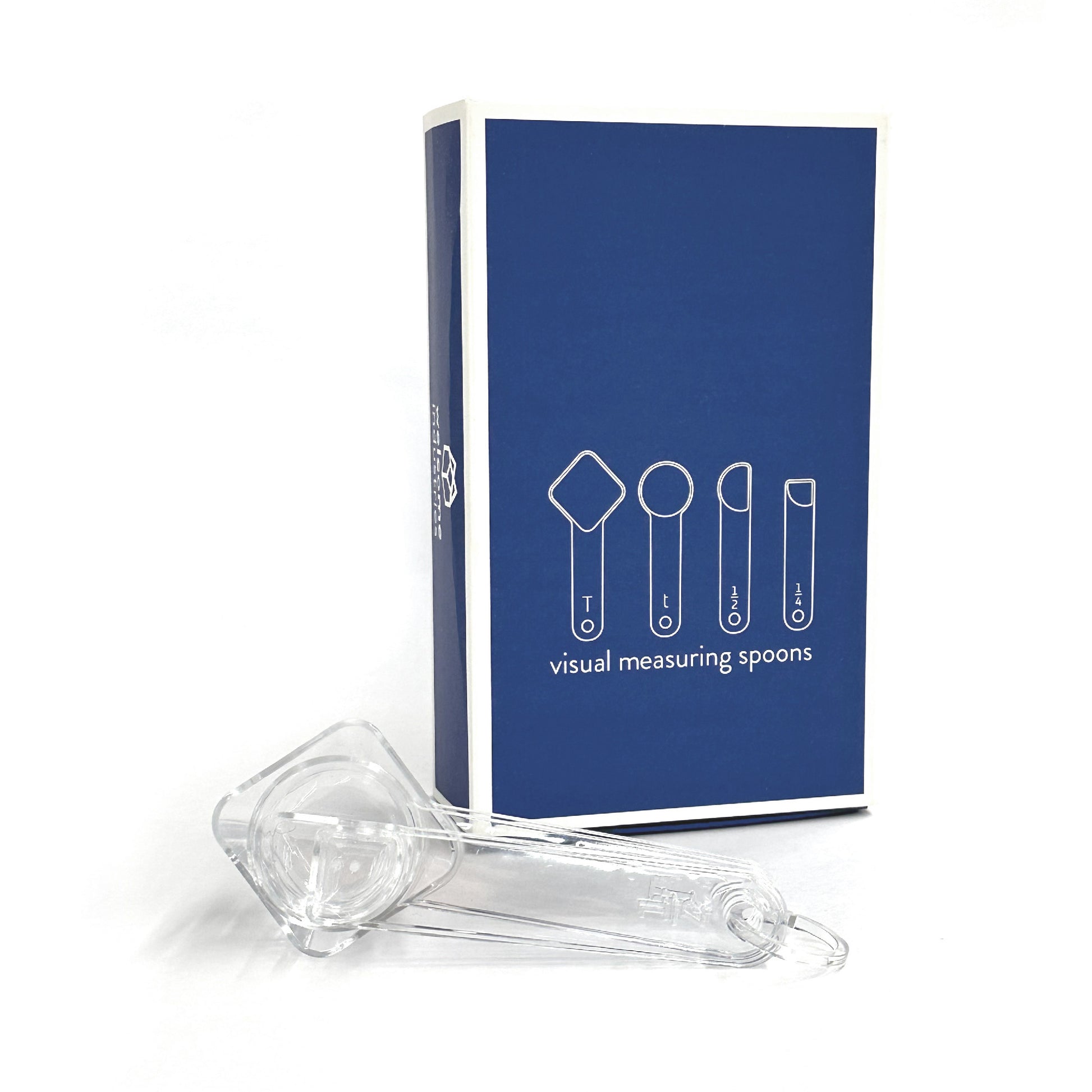 nested visual measuring spoons rest on their side in front of blue gift-box packaging